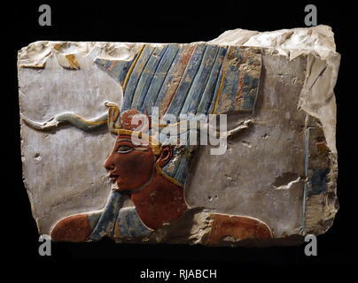 painted limestone relief depicting Amun-Min; New Kingdom; Deir el Bahri 1490-1436 BC. Amun was a major ancient Egyptian deity who appears as a member of the Hermopolitan Ogdoad. Min was an ancient Egyptian god whose cult originated in the Predynastic period Stock Photo