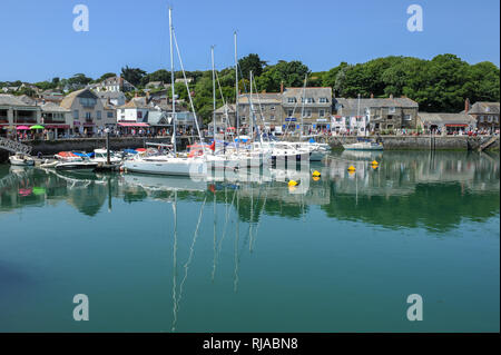 Sailing boats floating on the water during high tide on a summers day in Padstow Harbour, Cornwall, England. Stock Photo