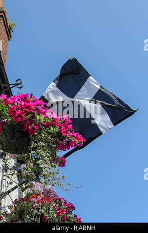 Saint Piran's Flag, the flag of Cornwall, flying outside a pub in Padstow, Cornwall, England. Stock Photo