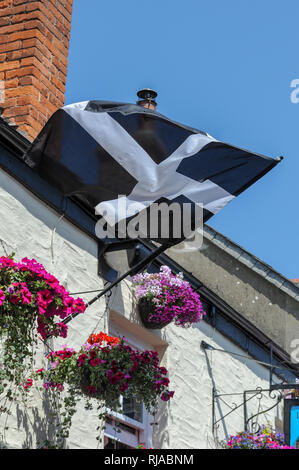 Saint Piran's Flag, the flag of Cornwall, flying outside a pub in Padstow, Cornwall, England. Stock Photo