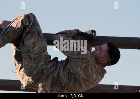 Sgt. James W. Peterson, Intel & Sustainment Co, 40th Infantry Division, California Army National Guard, struggles in The Weave, an obstacle course event that requires competitors to go over and under an overhead beam during California’s 2017 Best Warrior Competition Nov. 1-5, 2016, at Camp San Luis Obispo, San Luis Obispo, California. (Army National Guard Stock Photo