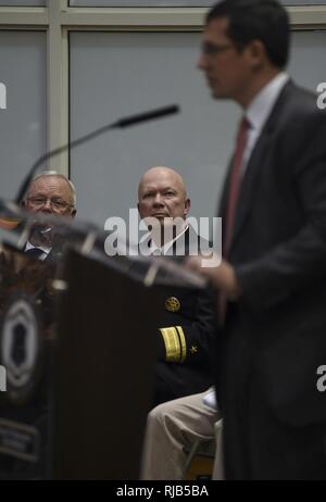 PROVIDENCE, R.I. (Nov. 5, 2016) Rear Adm. Jeffrey A. Harley, president, U.S. Naval War College, listens to the keynote address from Craig M. Mullaney, a strategic partner manager at Facebook and an Army combat veteran, during a ceremony honoring U.S. military veterans at the Rhode Island Department of Education building. The ceremony was followed by a torch procession by veterans who walked from the Department of Education building to Waterplace Park for the “Waterfire Salute to Veterans.” Stock Photo