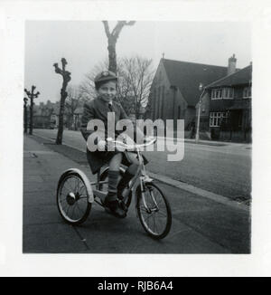 Little boy on a tricycle in a suburban street Stock Photo