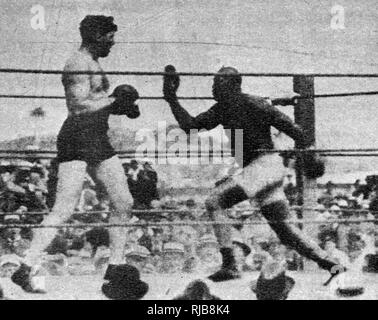 Jack Johnson (1878-1946), nicknamed the Galveston Giant, African-American world heavyweight champion boxer, 1908-1915, in the world heavyweight title match (in Havana, Cuba) on 5 April 1915 against Jess Willard (1881-1968), American heavyweight boxer, nicknamed the Pottawatomie Giant. Willard won by a knockout in the 26th round.