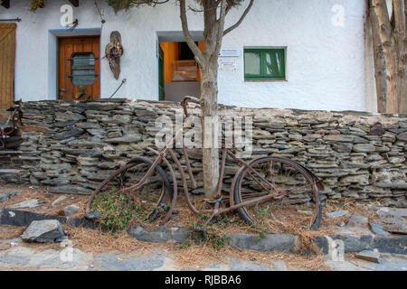 Old rusty bicycle in Port Lligat on Cap de Creus peninsula in Cadaques, Spain, where the world famous artist Salvidor Dali had a house. Stock Photo