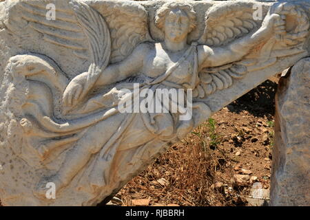 Stone relief of, the goddess of victory Nike in the ancient city of Ephesus. Stock Photo
