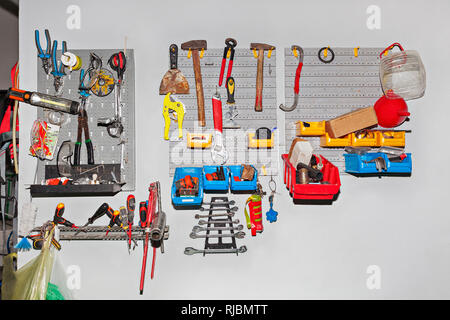 Big assortment of different tools hanging on wall at workshop - Repair concept Stock Photo