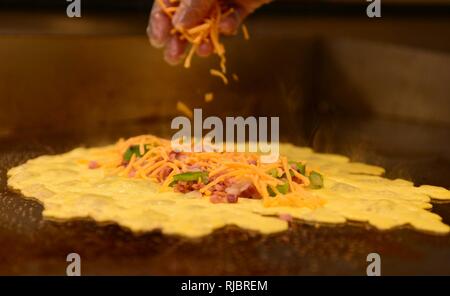 A ham and cheese omelet is prepared for a customer during the breakfast rush inside the Raider Café at Ellsworth Air Force Base, S.D., Jan. 12, 2018. Having won the Hennessey award several times in the past, an award recognizing the best dining facilities in the Air Force, food service personnel of the 28th FSS gear up to compete in this year’s competition. Stock Photo