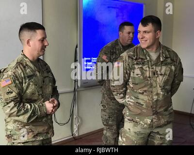 YAVORIV, UKRAINE -- Joint Multinational Training Group -Ukraine -  Newly promoted 1st. Lt. Christopher McKay of Delta Company (FSC) is given words of wisdom and guidance by the Battalion Commander Lt. Col. William Murphy on 16 January 2018. Stock Photo