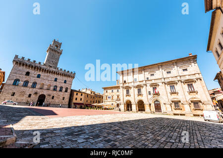 Montepulciano, Italy - August 28, 2018: Street in small town village in Tuscany during day on sunny summer day with piazza square wide angle view Stock Photo
