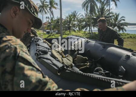 U.S. Marines secure a Combat Rubber Reconnaissance Craft (CRRC) onto a truck at Ream Naval Base, Sihanoukville, Cambodia, Nov. 2, 2016. U.S. Marines instructed the Cambodian Sailors on CRRC operation and amphibious raids during Cooperation Afloat Readiness and Training (CARAT) 16. CARAT 2016 is a nine-country, bilateral exercise series between the United States and Bangladesh, Brunei, Cambodia, Indonesia, Malaysia, Singapore, the Philippines, Thailand, and Timor-Leste. This phase of CARAT focuses on partnerships between the forces of the US and Cambodia, and Brunei. As the premier naval engage Stock Photo