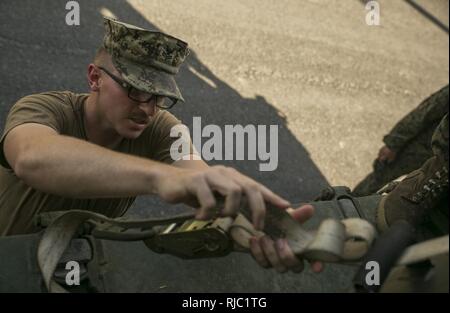 U.S. Navy Petty Officer 2nd Class Jacob Trevethan secures Combat Rubber Reconnaissance Craft (CRRC) onto a truck at Ream Naval Base, Sihanoukville, Cambodia, Nov. 2, 2016. U.S. Marines instructed the Cambodian Sailors on CRRC operation and amphibious raids during Cooperation Afloat Readiness and Training (CARAT) 16. CARAT 2016 is a nine-country, bilateral exercise series between the United States and Bangladesh, Brunei, Cambodia, Indonesia, Malaysia, Singapore, the Philippines, Thailand, and Timor-Leste. This phase of CARAT focuses on partnerships between the forces of the US and Cambodia, and Stock Photo