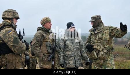 YAVORIV,Ukraine--Sgt. 1st. Class Richard Fredericks, a platoon sergeant assigned to 6th Squadron, 8th Cavalry Regiment, 2nd Infantry Brigade Combat Team, 3rd Infantry Division speaks with Ukrainian Soldiers assigned to 1st Battalion, 80th Airmobile Brigade before conducting an entering and clearing trenches exercise, Nov. 2, at the International Peacekeeping and Security Center. Soldiers of 6-8 CAV are currently responsible for training Ukrainian ground forces as part of the Joint Multinational Training Group-Ukraine. JMTG-U is training designed to reinforce defensive skills of the Ukrainian G