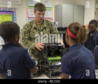 BATON ROUGE, La. (Nov. 1, 2016) — Petty Officer 3rd Class Darren Hauk, assigned to Explosive Ordnance Disposal Group (EODGRU) 2, explains the capabilities of the Seabotix Remote Operated Vehicle to students of the Scotlandville Pre-Engineering Magnet Academy robotics class as part of Baton Rouge Navy Week 2016. Baton Rouge is one of select cities to host the 2016 Navy Week, a week dedicated to raising U.S. Navy awareness through local outreach, community service and exhibitions. Stock Photo