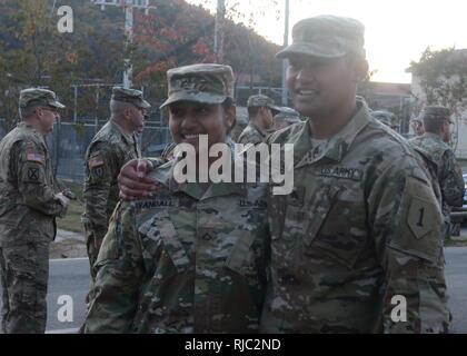 CAMP CASEY, Republic of Korea – Pfc. Josephine Yandall (left), a human resources specialist with 2nd Battalion, 1st Air Defense Artillery Regiment, 35th ADA Brigade, stands with her brother, Sgt. Benjamin Yandall (right), a tank crewmember with 2nd Battalion, 34th Armor Regiment, 1st Armored Brigade Combat Team, 1st Infantry Division, following Benjamin’s promotion ceremony Nov. 1. Benjamin was promoted to the rank of sergeant by his sister during the ceremony, a unique experience given that both Soldiers are currently assigned to the Korean peninsula. ( Stock Photo