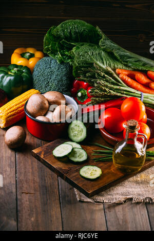 Vegetables and utensils on kitchen table Stock Photo