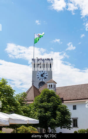 View at clock tower of Ljubljana castle with town flag in Slovenia Stock Photo