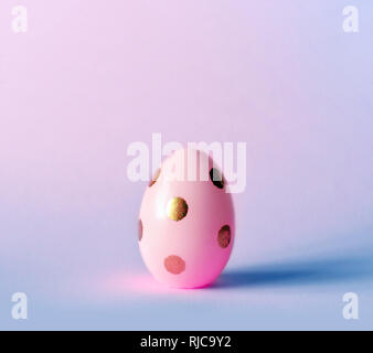 Easter egg on pastel purple background. Happy Easter concept. Minimal concept Stock Photo
