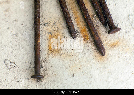 Rusty nails on concrete. Stock Photo