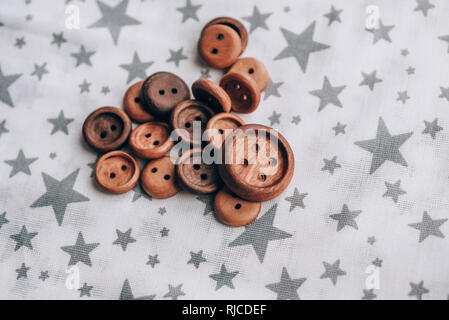 handmade wooden buttons on beautiful cotton fabric in grey stars Stock Photo