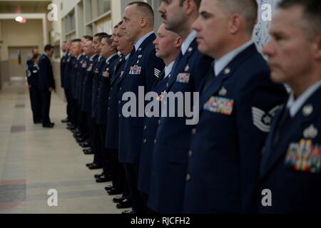 Members of the 155th Civil Engineering Squadron stand at attention for a Class A dress blues inspection Jan. 7, 2018, at the 155th Air Refueling Wing, Nebraska National Guard air base, Lincoln, Nebraska. The CES conducts an inspection every year. 'We just want to make sure everybody's uniforms are up-to-date and ready to go,' said Senior Master Sgt. Sarah Bredthauer, the CE Operations Flight Superintendent. 'You never know when you're going to wear your blues, and most of the time it's very unexpected.' Stock Photo