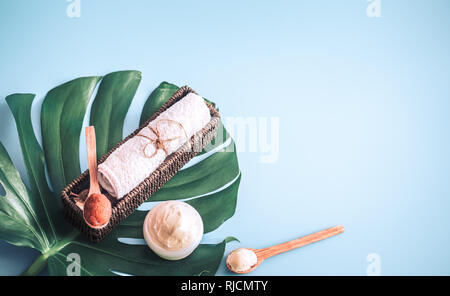 Composition of spa items on a color blue background with a tropical leaf, the concept of body care and spa treatments Stock Photo