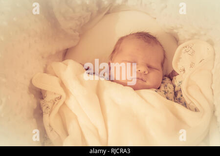 Baby sleeping. new born baby. infant asleep in cot wrapped in blanket. Stock Photo