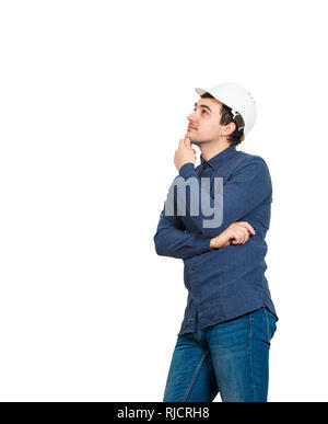 Wise engineer holding hand under chin thoughtful looking up wearing protective helmet isolated over white background. Stock Photo