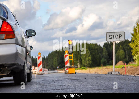 A row of cars at the road repair semaphore, selective focus, blurred background - image Stock Photo