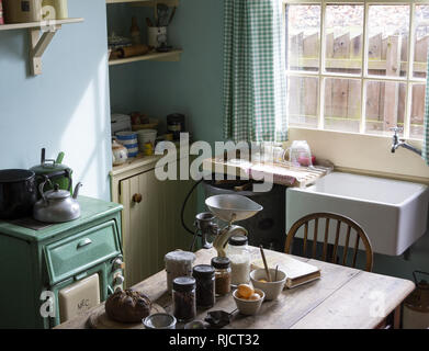 A 1930's domestic kitchen/dining room in the back to back housing at the Black Country Living Museum in Dudley, West Midlands, England, UK Stock Photo