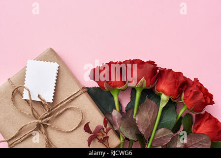 pink roses bouquet in kraft paper isolated on white with copy space,  wedding flowers bouquet concept Stock Photo