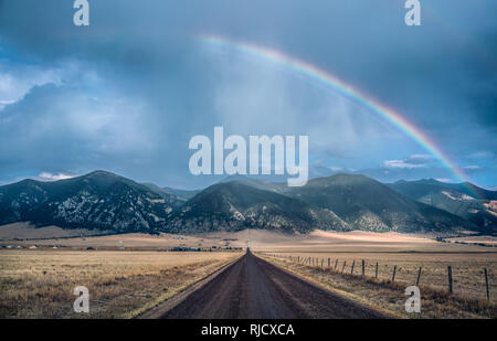 Rainbow over the mountains in Montana Stock Photo