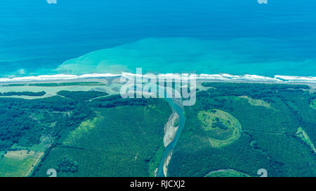 An aerial photo of the beautiful landscape of the Pacific coast of Costa Rica. Turquoise blue ocean and a estuary of a river can be seen. Stock Photo