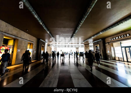 Florence, Italy - August 30, 2018: Inside Santa Maria Novella Firenze train station with tourists people with luggage walking crowd in dark passage Stock Photo