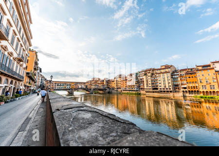 Florence, Italy - August 30, 2018: Firenze orange yellow colorful buildings and Arno river during summer morning sunrise in Tuscany Stock Photo
