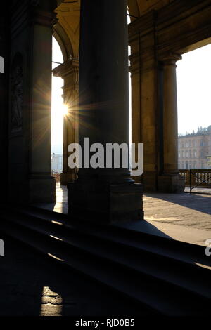 Early morning sunlight casting long shadows through the columns of the entrance to the Uffizi Gallery on the banks of the River Arno Florence Italy Stock Photo