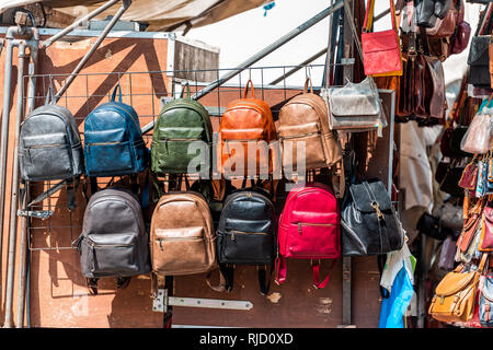 Florence, Italy Many leather purse bags colorful vibrant colors hanging on display in shopping street market in Firenze in Tuscany Stock Photo
