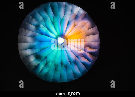 Convex or concave? Optical illusion created by light  and big parabolic light shaper tool in photography studio. Stock Photo