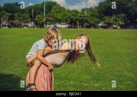 Mom and son on background of Padang Kota Lama or simply called The Padang, is the parade ground and playing field created by the British colonials in  Stock Photo