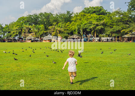 Boy on Padang Kota Lama or simply called The Padang, is the parade ground and playing field created by the British colonials in the civic district of  Stock Photo