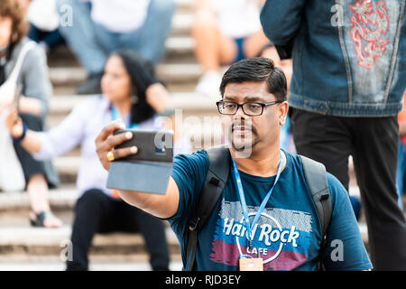 Rome, Italy - September 4, 2018: Historic city with famous Spanish Steps on summer day and closeup portrait of one Indian man tourist taking selfie pi Stock Photo