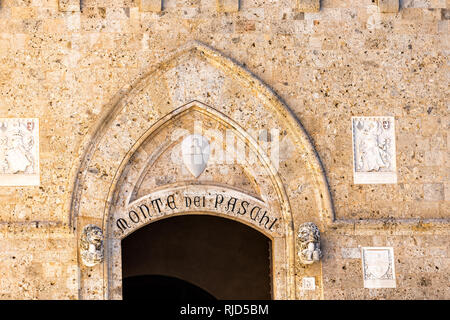 Siena, Italy - August 27, 2018: Sign in historic medieval old town village in Tuscany for Monte dei Paschi Sienna entrance on building Stock Photo