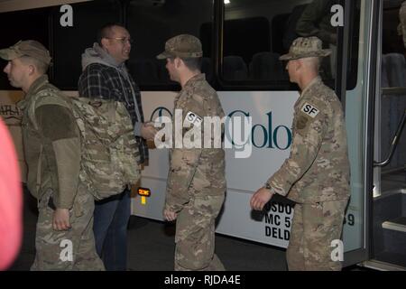 Defenders assigned to the 436th Security Forces Squadron return home from deployment to the Middle East Jan. 21, 2018, at Dover Air Force Base, Del. The 12 Defenders departed the bus after a long day of flights returning them to Dover AFB. Stock Photo