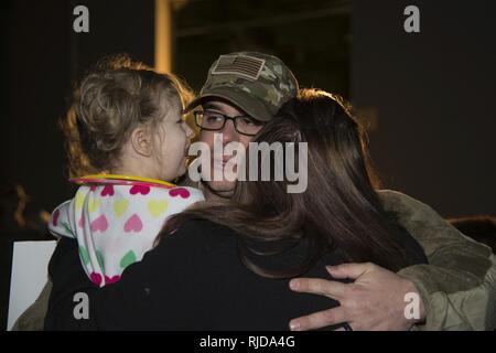 Master Sgt. Michael Johnson, 436th Security Forces Squadron defender, embraces his daughter, Amelia, and wife, Kelly, upon his return home from deployment Jan. 21, 2018, at Dover Air Force Base, Del. Johnson’s team was deployed to the Middle East for six months. Stock Photo