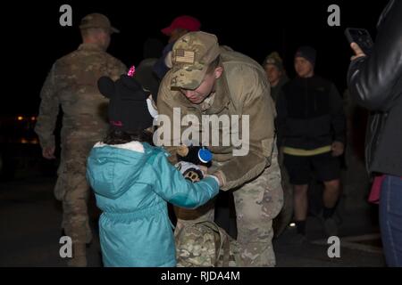 Staff Sgt. Justin Stevenson, 436th Security Forces Squadron defender, hands a stuffed animal to his daughter, Julia, Jan. 21, 2018, at Dover Air Force Base, Del. Stevenson and 11 of his wingmen returned early that morning from a six-month deployment to the Middle East. Stock Photo