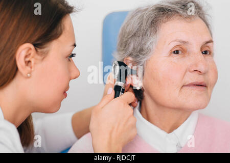 Elderly patient during an ear examination, ear exam at clinic. Stock Photo