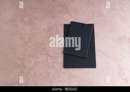 two black price tags isolated on decorative textured background