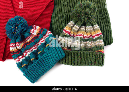 Two bobble ski hats and scarves isolated Stock Photo