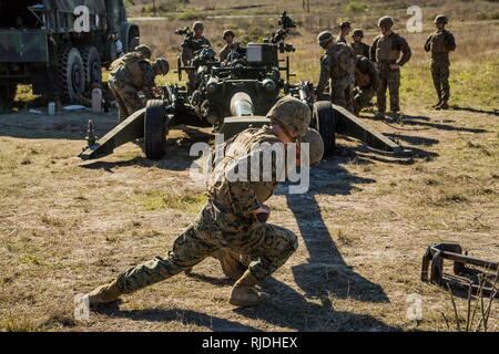 U. S. Marines from Artillery Training School (ATS) Section Chief Course 1-18 conducts a performance evaluation on the operation of the M777  Light Towed Howitzer aboard Camp Pendleton Calif., 22, Jan 2018. The section chiefs course enables Marines who show leadership potential to become supervisors of an M777 operations team. Stock Photo