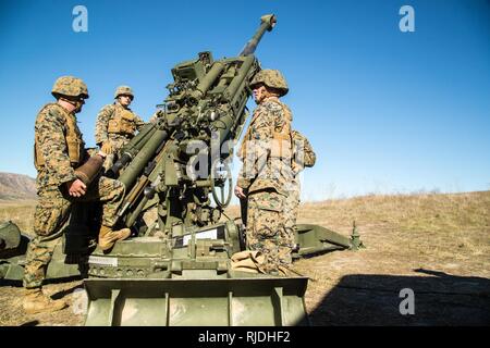 U. S. Marines from Artillery Training School (ATS) Section Chief Course 1-18 conducts a performance evaluation on the operation of the M777  Light Towed Howitzer aboard Camp Pendleton Calif., 22, Jan 2018. The section chiefs course enables Marines who show leadership potential to become supervisors of an M777 operations team. Stock Photo